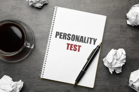 Notebook with text Personality Test, pen and crumpled sheets of paper on grey Stock Photos
