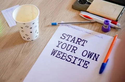 Notebook with text START YOUR OWN WEBSITE on wooden table with pen Stock Photos