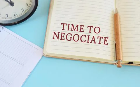 Notebook with text Time To Negotiate on bright blue background.Conceptual pho Stock Photos