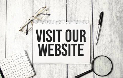 Notebook with the text visit our website. Close-up of the workplace. Business Stock Photos