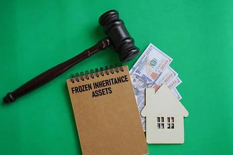 Notebook title FROZEN INHERITANCE ASSETS. Financial concept Stock Photos