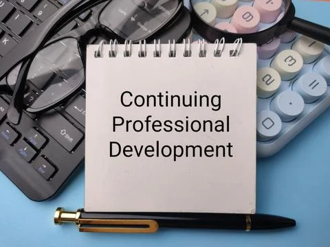 A notebook titled Continuing Professional Development sits on a desk with a.. Stock Photos