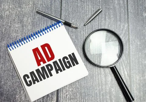 Notebook with Tools and Notes About ad campaign Stock Photos