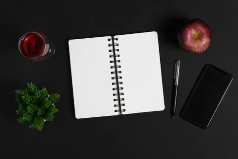 Notebook on top of black background. Stock Photos