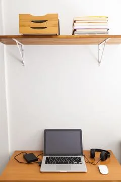 Notebook on top of a home office desk. Copy space. Workspace and technology.  Stock Photos