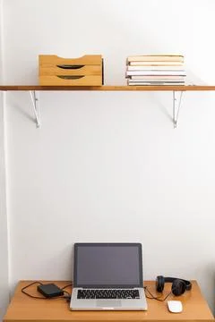 Notebook on top of a home office desk. Copy space. Workspace and technology.  Stock Photos