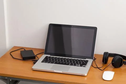 Notebook on top of a home office desk. Copy space. Workspace and technology.  Stock Photos