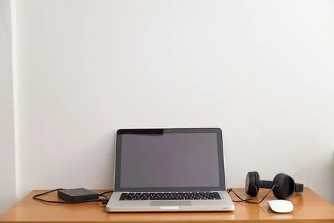 Notebook on top of a home office desk. Copy space. Workspace and technology.  Stock Photos