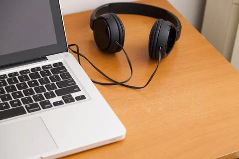 Notebook on top of a home office desk. Copy space. Workspace and technology.  Stock Photos