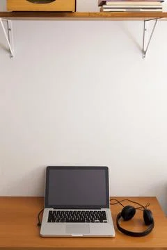 Notebook on top of a home office desk. Copy space. Workspace and technology.  Stock Photos