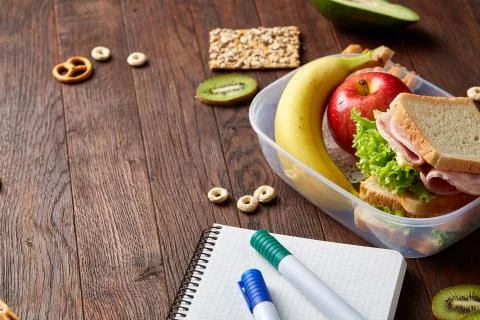 A notebook, two markers and assortment of cookies on a wooden table, copy space Stock Photos