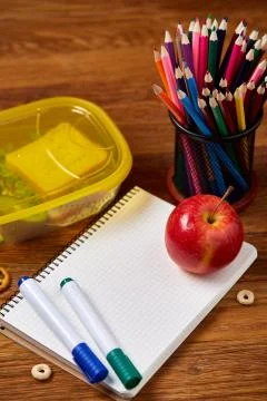 A notebook, two markers and assortment of cookies on a wooden table, copy space Stock Photos