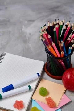A notebook, two markers and assortment of jelly beans on a white background Stock Photos