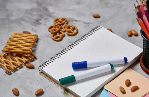 A notebook, two markers and assortment of jelly beans on a white background Stock Photos