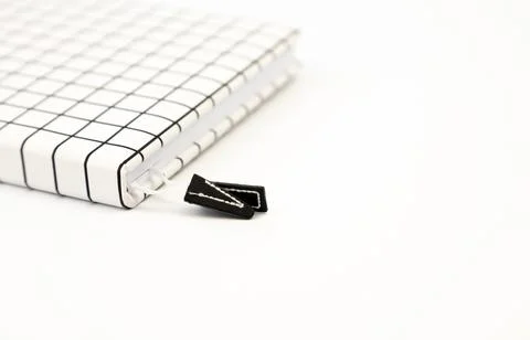 Notebook in a white cell on a white background. Place for text. 库存照片