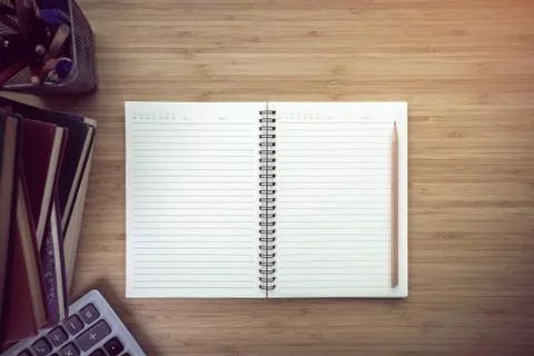 Notebook on wood table background. Stock Photos