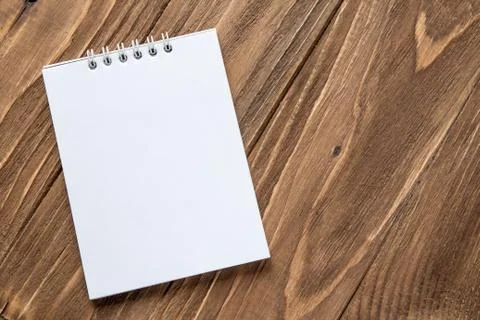 Notebook on wooden background Stock Photos