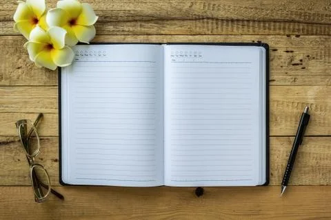 Notebook on wooden table Stock Photos