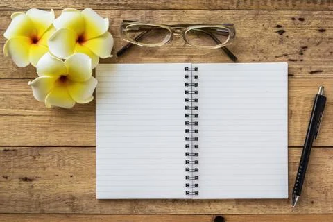 Notebook on wooden table Stock Photos