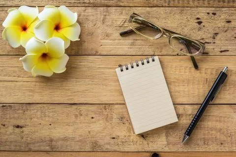 Notebook on wooden table Stock Photos