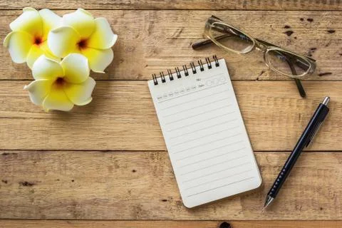 Notebook on wooden table Stock Photos