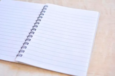 Notebook on wooden table Stock Photos