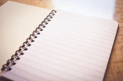 Notebook on wooden table Stock Photos