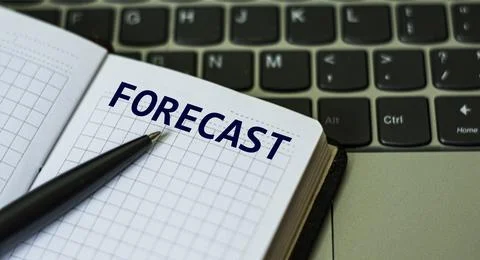 Notebook with the word FORECAST , on the background of a laptop Stock Photos