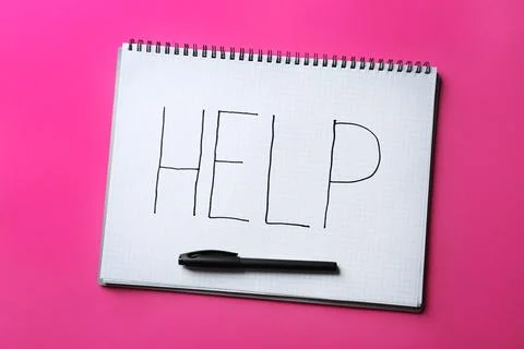 Notebook with word HELP and marker on color background, top view Stock Photos