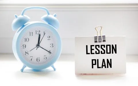 A notebook with the word Lesson Plan written on a white background with a clo Stock Photos
