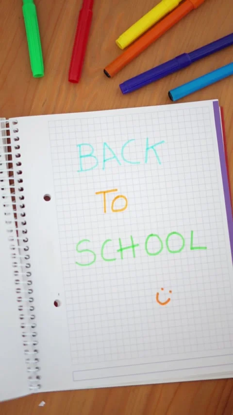 Notebook with the words "Back to school" written with colored markers. Stock Footage 279309870