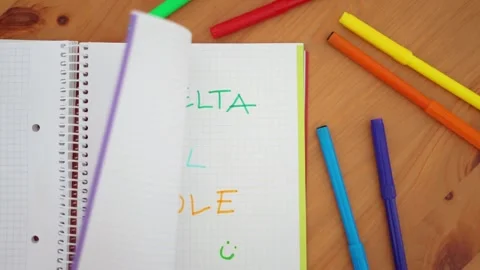 Notebook with the words "Back to school" written in Spanish with colored ma.. Stock Footage 279309872