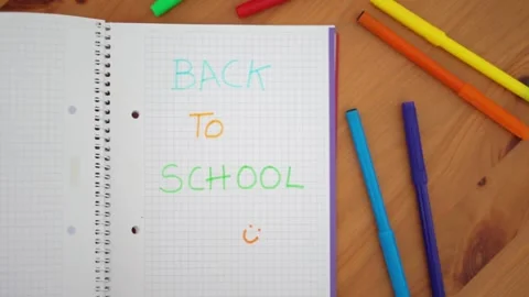 Notebook with the words "Back to school" written with colored markers. Stock Footage 279309873