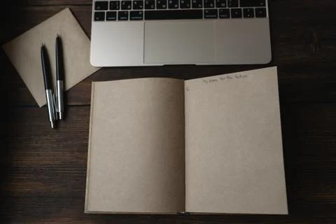 Notebook with the words My plans for the future with a pen next to a laptop Stock Photos