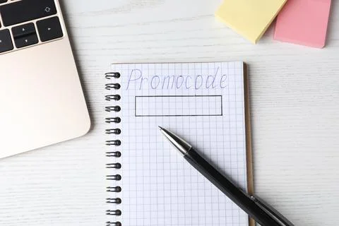 Notebook with words Promo Code, pen, laptop and sticky notes on white wooden  Stock Photos