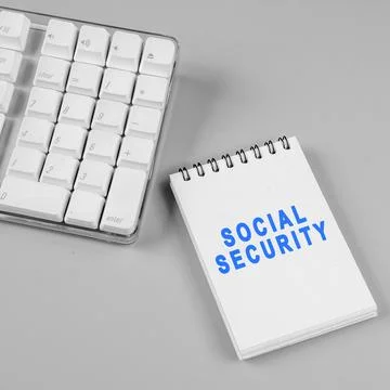 Notebook with the words of Social Security accompanied by a computer keyboa.. Stock Photos