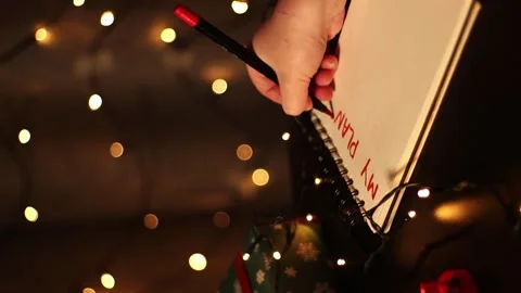 Notebook with written plans for new year 2025 in Christmas decoration. Stock Footage 293918282