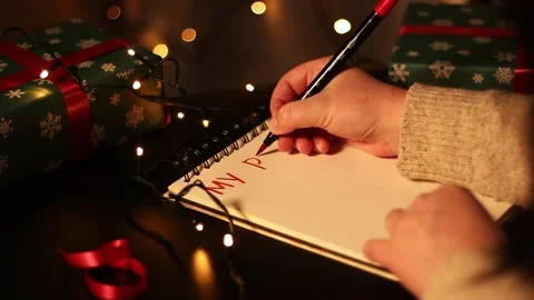 Notebook with written plans for new year 2025 in Christmas decoration. Stock Footage 293918479