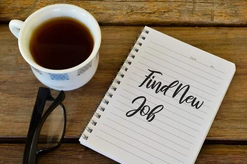 Notebook written with text FIND NEW JOB over wooden background. Stock Photos