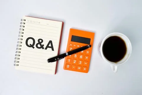 Notebook written with text Q&amp;A over white background. Stock Photos