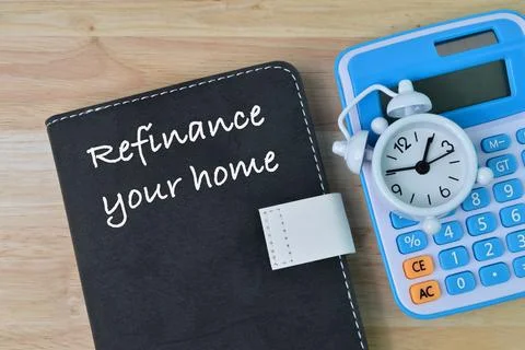Notebook written with text REFINANCE YOUR HOME Stock Photos