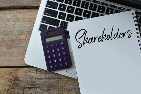 Notebook written with text SHAREHOLDERS over wooden background. Stock Photos