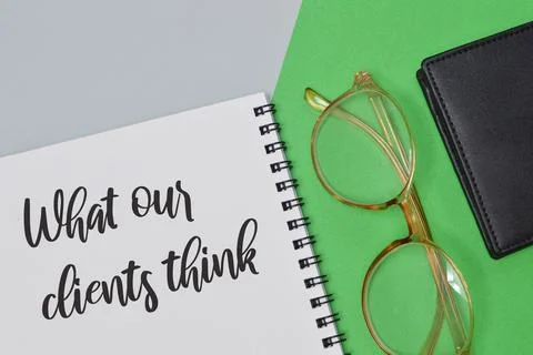 Notebook written with text WHAT OUR CLIENTS THINK. Business concept. Stock Photos