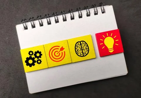 Notebook,colored cubes with icons, ideas and management targets. business con Stock Photos