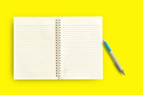 Notebook,pen on a yellow background. top view copy space Stock Photos