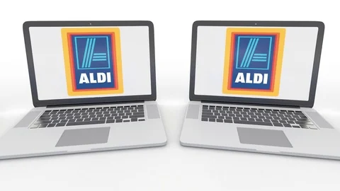 Notebooks with Aldi logo on the screen. Computer technology conceptual editorial Stock Footage