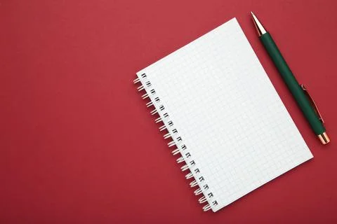 Notebooks and pen on red background, top view. Space for text Stock Photos