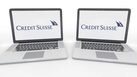 Notebooks with Credit Suisse Group logo on the screen. Computer technology Stock Footage