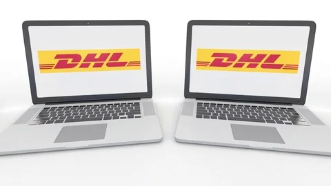 Notebooks with DHL Express logo on the screen. Computer technology conceptual Stock Footage