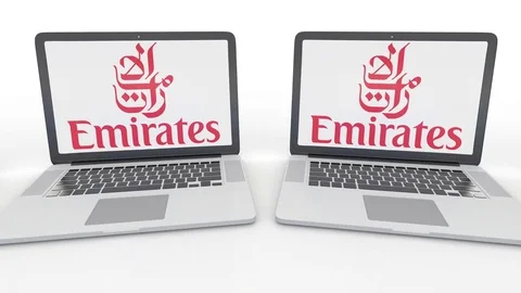 Notebooks with Emirates Airline logo on the screen. Computer technology Stock Footage